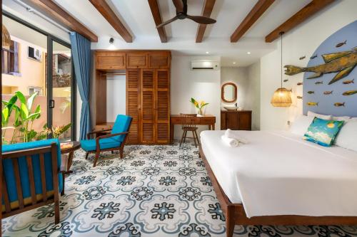 a bedroom with a large white bed and a desk at An Bang Beach Coastal Calm House 4BR Hoi An in An Bang