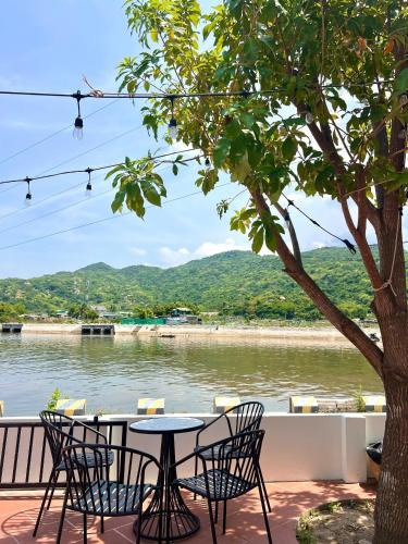 a table and chairs with a view of a river at Homestay Làng Biển in Ninh Hải