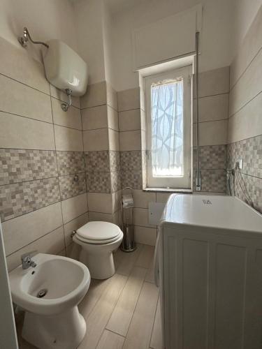 a bathroom with a toilet and a sink and a tub at Blue House in Santa Maria La Carità