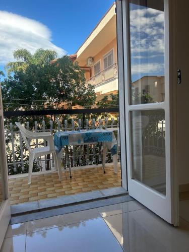 an open door to a balcony with a table and chairs at Blue House in Santa Maria La Carità