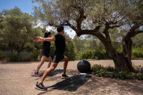 two people playing with a ball in a park at Mercure Brignoles Golf de Barbaroux & Spa in Brignoles