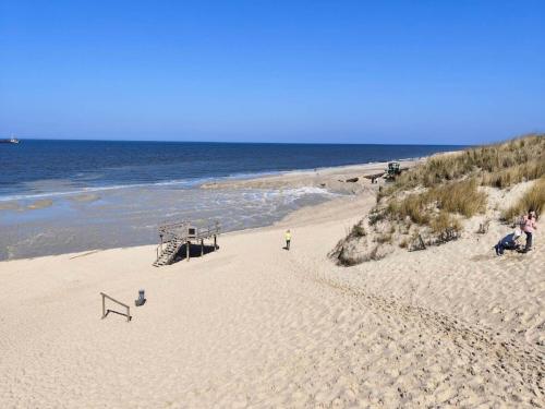 a beach with a volley ball net on the sand at Apartment house Katharina, Westerland in Westerland (Sylt)