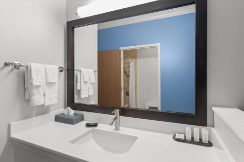 a bathroom with a sink and a large mirror at La Quinta by Wyndham Moab in Moab