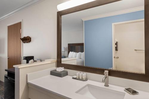 a bathroom with a sink and a large mirror at La Quinta by Wyndham Moab in Moab