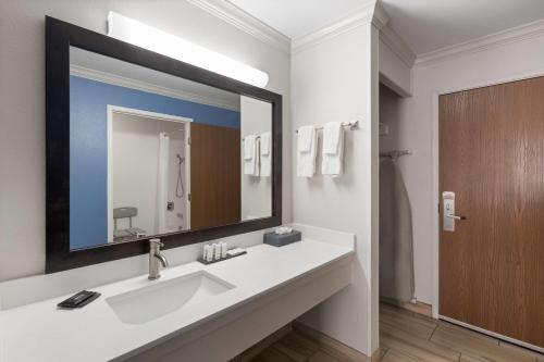 a bathroom with a sink and a large mirror at La Quinta by Wyndham Moab in Moab