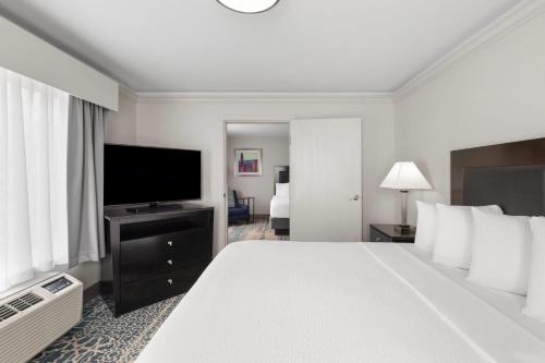 a hotel room with a bed and a flat screen tv at La Quinta by Wyndham Moab in Moab
