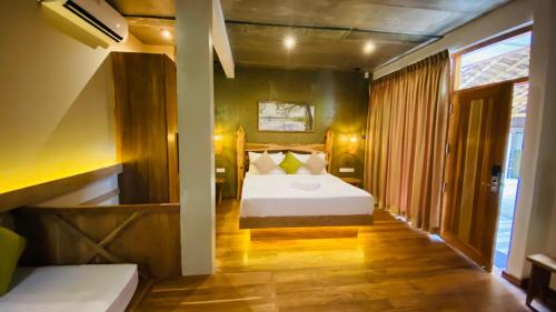a bedroom with a white bed in a room at Wilpattu Safari Resort in Wilpattu