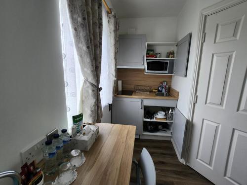a small kitchen with a table and a window at Cozy Room,Private Bathroom,Private Kitchynete in Dublin