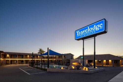 a sign in front of a hotel with a sign at Travelodge by Wyndham Parker in Parker