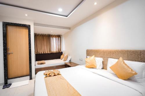 a hotel room with a bed and a couch at Hotel Konark - Vijay Nagar in Indore