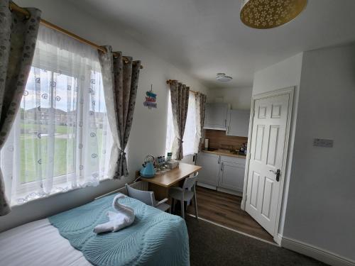 a bedroom with a bed and a desk and a kitchen at Cozy Room,Private Bathroom,Private Kitchynete in Dublin