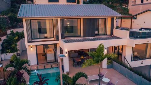 an aerial view of a house with a swimming pool at Villa Sunset St Gilles in Saint-Paul