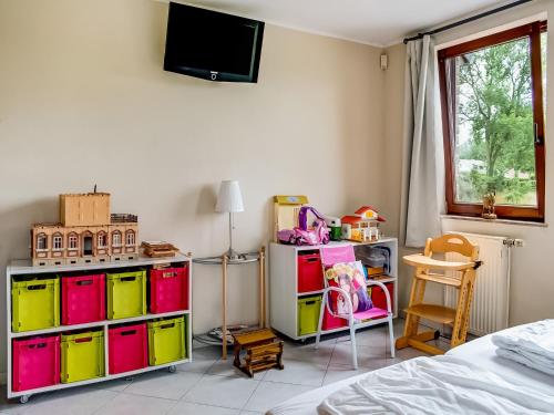 a bedroom with colorful drawers and a tv on the wall at Family Escape with Pool in Filot