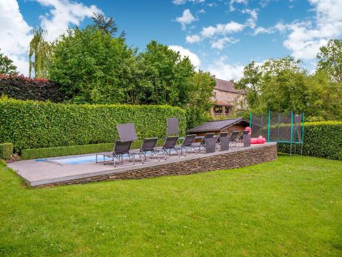 a group of chairs sitting on a patio with a gazebo at Family Escape with Pool in Filot
