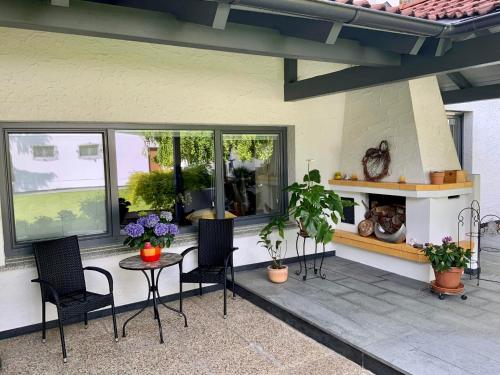 a patio with chairs and a table and some plants at Ferienhaus Kaltenberger in Laussa
