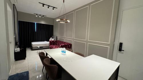 a room with a white table and chairs and a couch at Axon Residence Near Fehrenheit Bukit Bintang in Kuala Lumpur