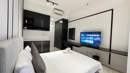 a bedroom with a bed and a flat screen tv at Axon Residence Near Fehrenheit Bukit Bintang in Kuala Lumpur