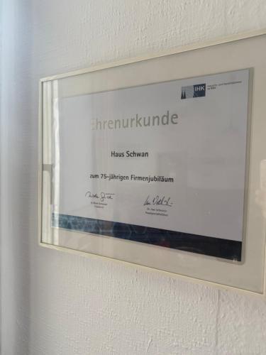 a framed sign on the wall of a room at Hotel Haus Schwan Köln in Cologne