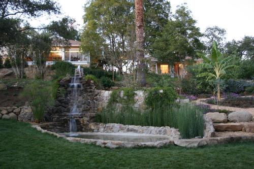 a waterfall in the middle of a yard with a yard at Ojai Retreat & Inn in Ojai