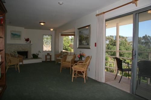 a living room with a deck with a table and chairs at Ojai Retreat & Inn in Ojai