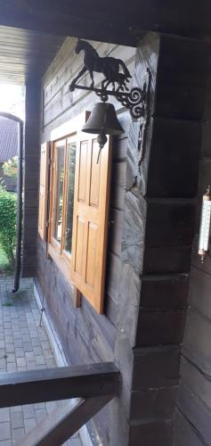 a light on the side of a building with a window at Vila Mera in Pabradė