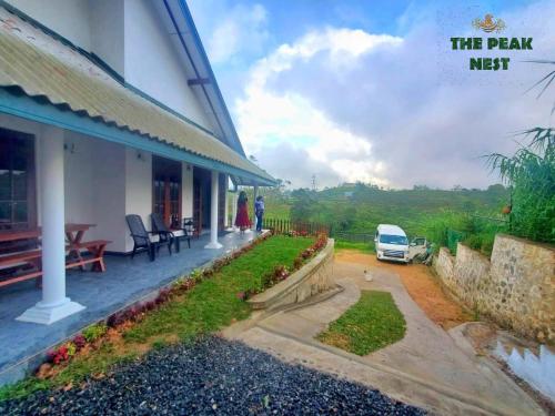 a porch of a house with a car parked outside at The Peak Nest in Nuwara Eliya