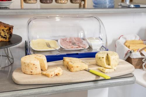 a bunch of cheese on a cutting board in a refrigerator at Garibaldi R&B in Messina