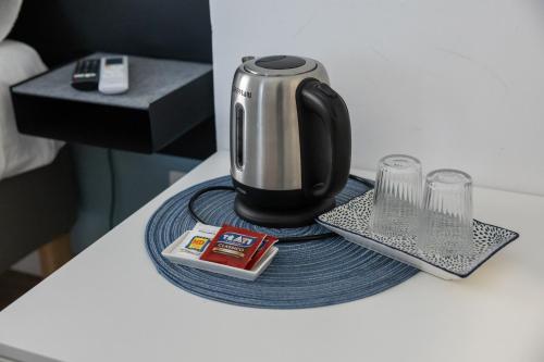 a coffee pot on a plate on a table at Garibaldi R&B in Messina