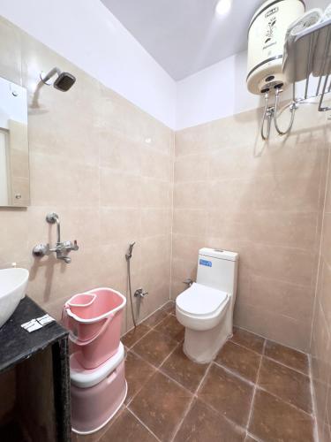 a bathroom with a toilet and a sink at Nath Palace in Varanasi