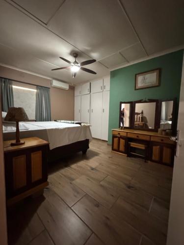 a large bedroom with a bed and a mirror at 21 A on Edgerton in Freeland Park