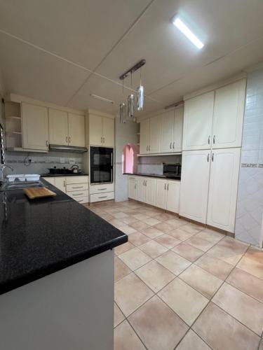 a large kitchen with white cabinets and black counter tops at 21 A on Edgerton in Freeland Park