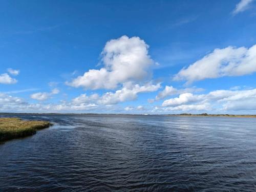 a large body of water with clouds in the sky at 6 person holiday home in Ringkøbing in Ringkøbing