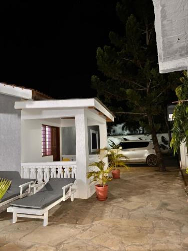 a small white building with a porch at night at Honeydream Villa & Studio Apartments in Diani Beach