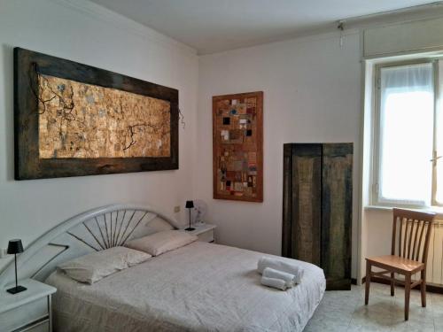 a bedroom with a bed and a chair and a window at Central Art House in Como