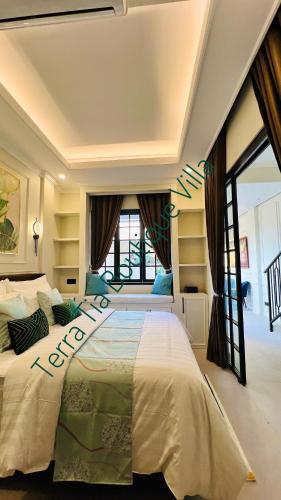 a bedroom with a large bed and a large window at Terra Tia Boutique Villa Senggigi in Senggigi 