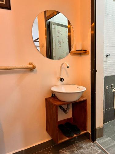 a bathroom with a sink and a mirror at Honeydream Villa & Studio Apartments in Diani Beach