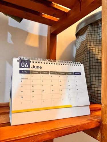 a calendar sitting on top of a wooden table at Honeydream Villa & Studio Apartments in Diani Beach