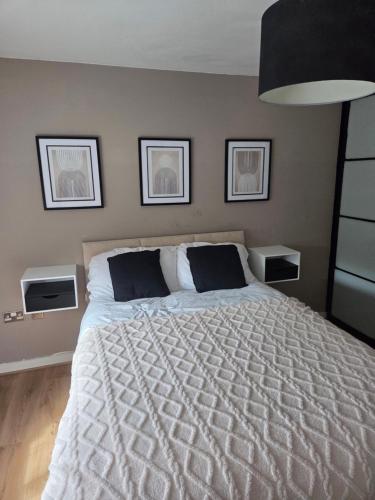 a bedroom with a large bed with two night stands at Wolverhampton Apartment with Free Parking 1 minute from the train station in Wolverhampton