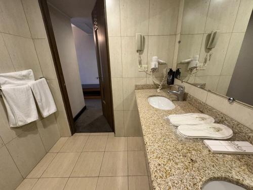 a bathroom with two sinks and a mirror at N Royal Residence By Nairi in Yerevan