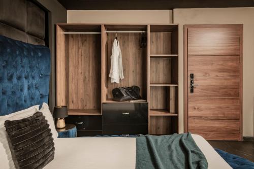 a bedroom with a bed and a wooden door at Damare Resort & SPA in St Paul's Bay