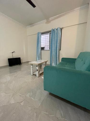 a living room with a couch and a table at Pearl 2bhk Baner Balewadi Hinjewadi in Pune