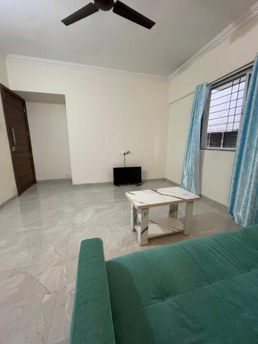 a living room with a couch and a table at Pearl 2bhk Baner Balewadi Hinjewadi in Pune