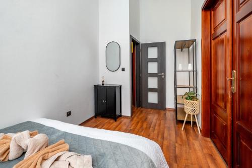 a bedroom with a bed and a wooden floor at U Lípy in Třeboň