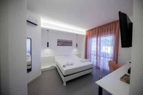 Ένα ή περισσότερα κρεβάτια σε δωμάτιο στο Borgo a Mare