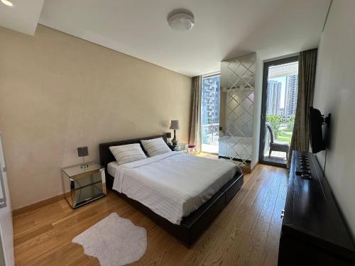 a bedroom with a bed and a large window at Queen Apartments Belgrade Waterfront in Belgrade