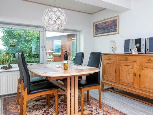 a dining room with a wooden table and chairs at 2 person holiday home in Gråsten in Gråsten