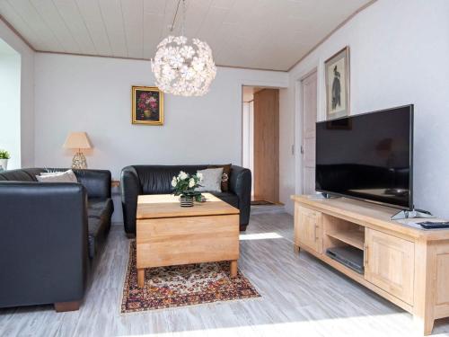a living room with a large flat screen tv at 2 person holiday home in Gråsten in Gråsten