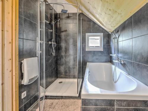 a bathroom with a shower and a bath tub at Chalet in Hohentauern by Ski Lift in Hohentauern