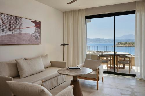 a living room with a couch and a table at JW Marriott Crete Resort & Spa in Marathi