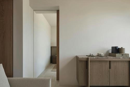 a living room with a table and a chair at JW Marriott Crete Resort & Spa in Marathi